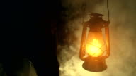 istock Man hand holding a kerosene lamp at night 1085557210