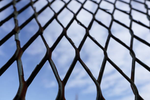 istock The sky through the fence 1085557480