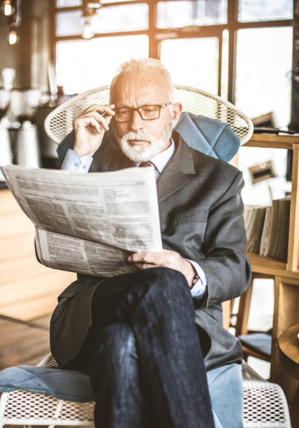 istock Senior businessman at his office riding newspapers . 1085566054