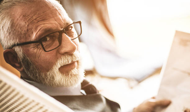 istock Senior businessman working with papers. Looking at camera. 1085567486