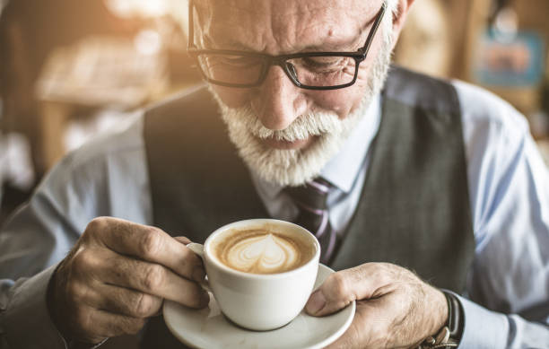 istock Close up image of senior businessman drinking coffee. 1085567968