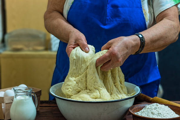 istock preparation, bakery,flour, dough, elderly woman, close up, copy space 1085571260