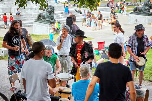 Montreal, Canada - June, 2018. Group of African American and Caucasian drummers and percussionists play rhythm at Tam Tams festival in Mount Royal Park, Montreal, Quebec, Canada. Editorial use.