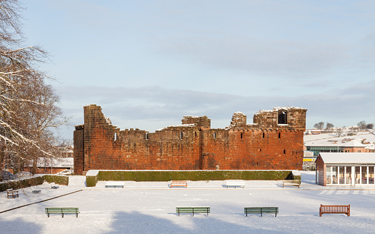 Penrith, England - January 17, 2016:  The view across Castle Park in Penrith, Cumbria towards Penrith Castle in northern England.  The 14th century castle is pictured on a winter morning.
