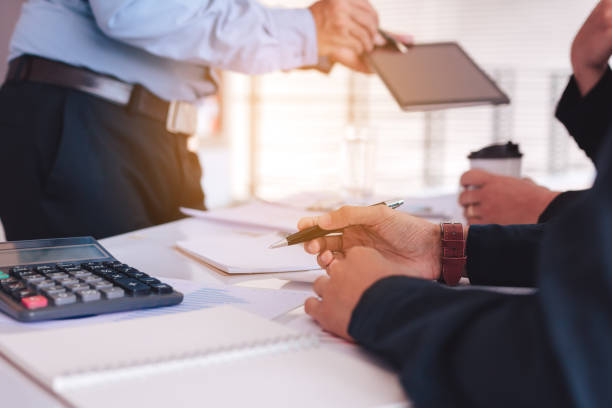 istock Business people examining financial reports and analyzing business growth. 1085590632