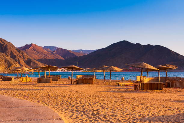 Egypt. Red sea day. Beach and umbrella Beautiful amazing nature background. Tropical blue water. Red sea. Beach and umbrella. Holiday resort. Fresh  freedom. Adventure day. Luxury paradise. Inspiring wilderness. taba stock pictures, royalty-free photos & images