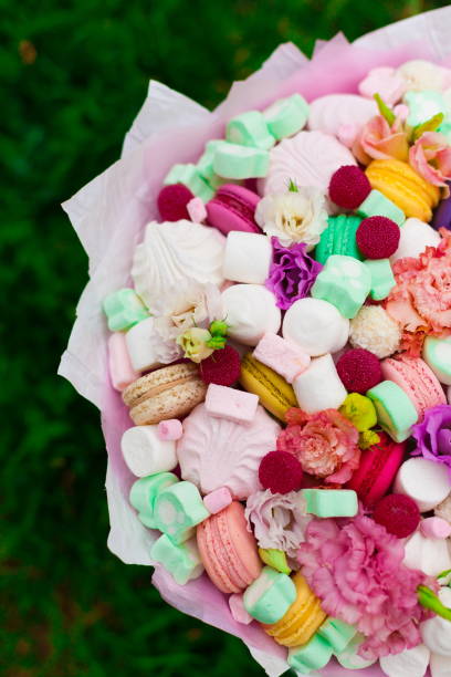 istock Flowers, fruit bouquet,  pink carnation, marshmallows, macaroons, nature 1085606156