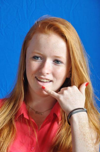 istock Teen miming a phone with her hand 1085606656