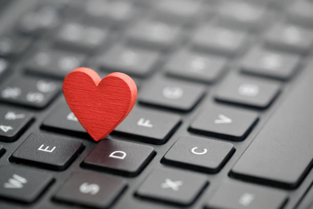 istock Small red heart on keyboard. Internet dating concept. 1085611060