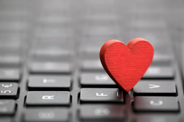 istock Small red heart on keyboard. Internet dating concept. 1085611168