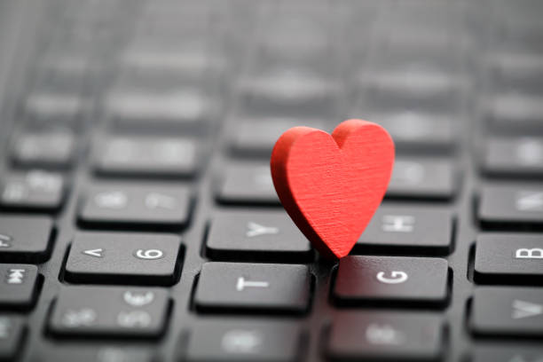 istock Small red heart on keyboard. Internet dating concept. 1085611220