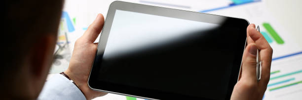 istock Businessman holds tablet on background 1085611900