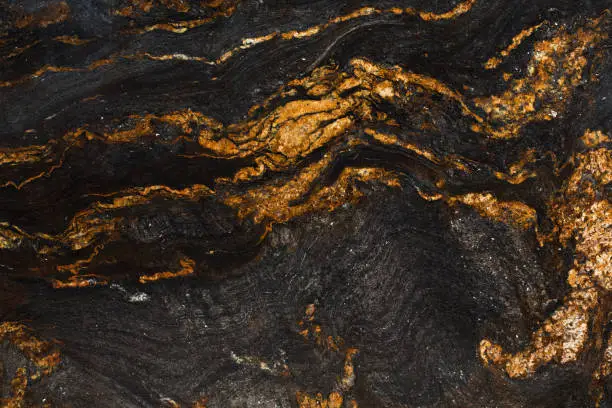 Photo of Natural slate with shades of gold and black.