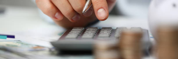 istock Male hand push key silver calculator is lying 1085613380