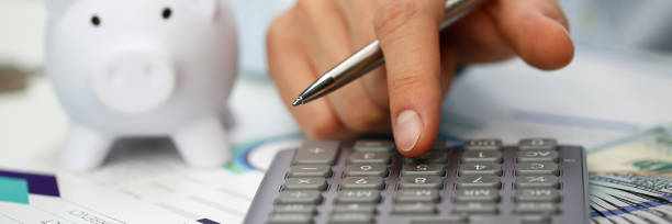 Male hand push key silver calculator is lying Male hand push key silver calculator is lying on desk cash dollar plots in home office setting. Calculation of family expenses social income population freelance irs situation growth research concept allowance stock pictures, royalty-free photos & images