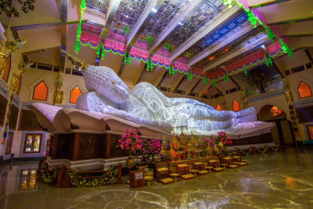 istock Buddha statue sleep at Thai temple beautiful and night light reflect on ground 1085613518