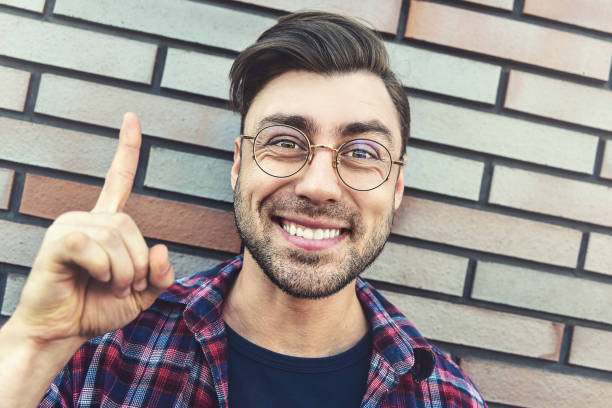 istock Surprised caucasian hipster with an idea or question pointing finger with happy face, number one. 1085616260