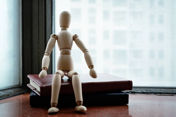 istock Woodman sitting on book after hard work on rainy day 1085622088