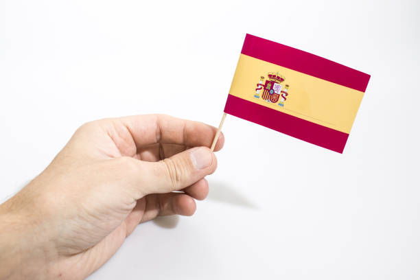 istock Hand is holding spain flag isolated in a white background composition 1085624386