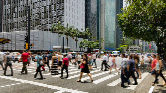 People on crosswalk. Blurred image.