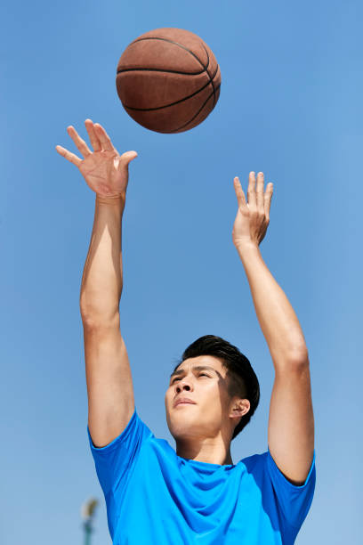 istock asian basketball player taking a shot 1085629126