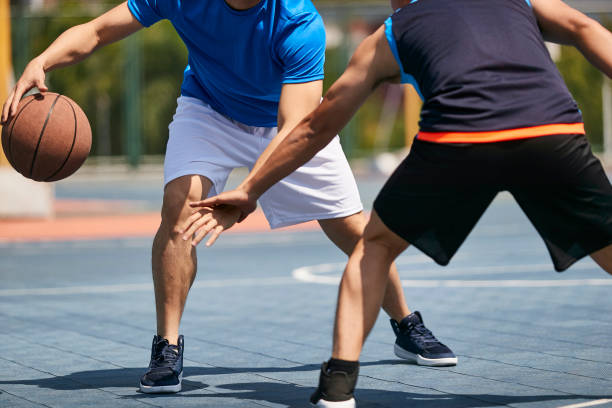 istock young adults playing basketball 1085629802
