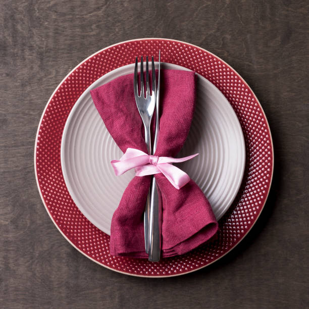 istock Christmas table place setting with empty gray and red plates with tableware at wood background 1085631728