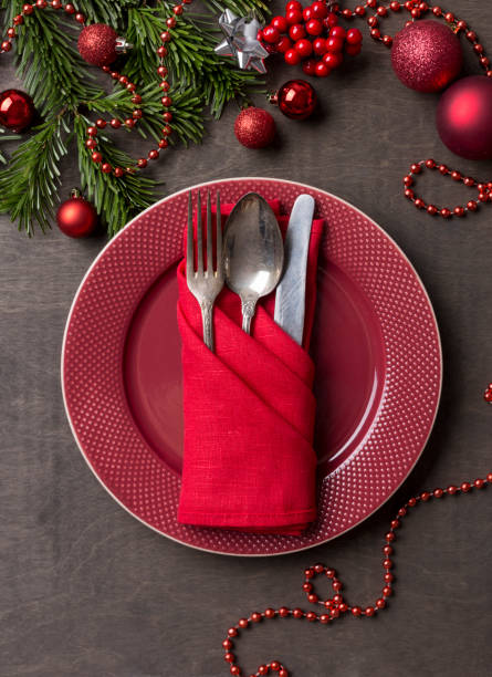 istock Holiday serving red plate with fork,spoon and knife at wood background 1085631752