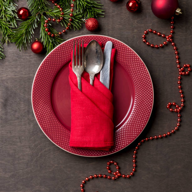 istock Holiday serving red plate with fork,spoon and knife at wood background 1085631772