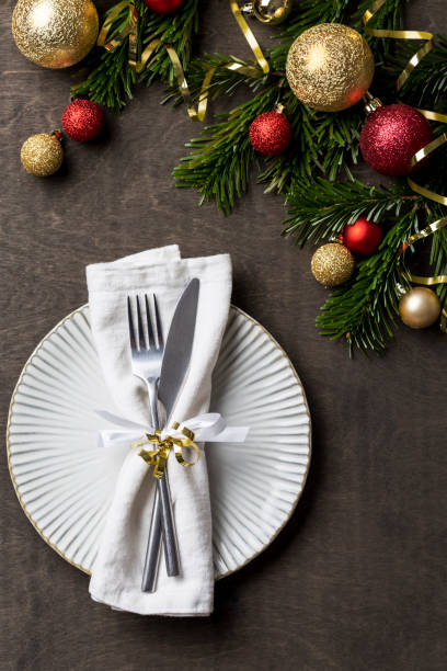 istock Christmas dinner table with white plate, fork, knife and napkin 1085631858