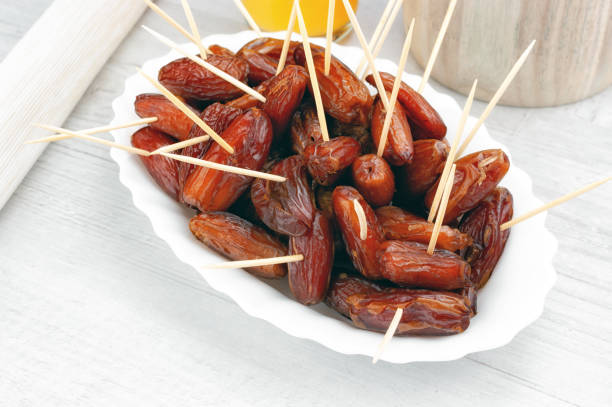 istock Dried dates fruit on wooden table 1085631860