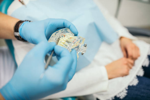 istock Dentist holding dental prosthetics teeth 1085634002