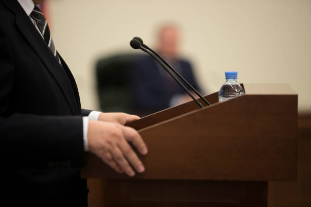 istock blurred of Businesswoman speech with microphone, hand gesturing protesting or belief concept for explaining in seminar meeting room 1085636514