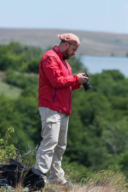 istock Photographer with a camera in the park. 1085638330