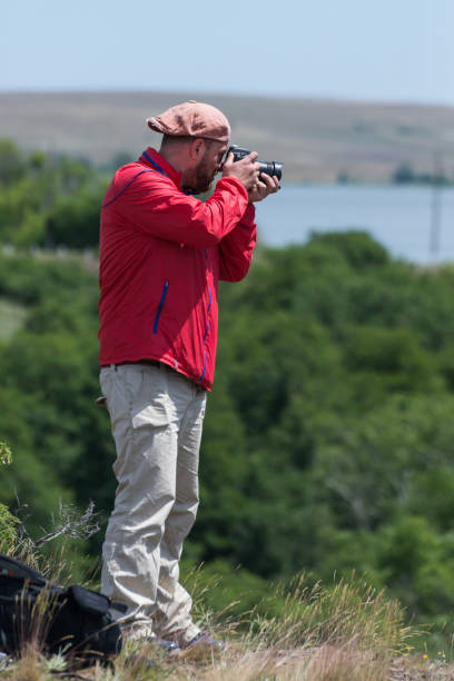 istock Photographer with a camera in the park. 1085638424