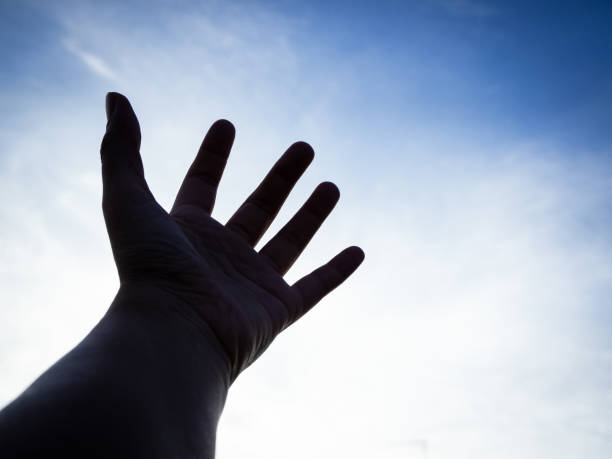 istock The silhouette humand hand reaching to the sky 1085642582