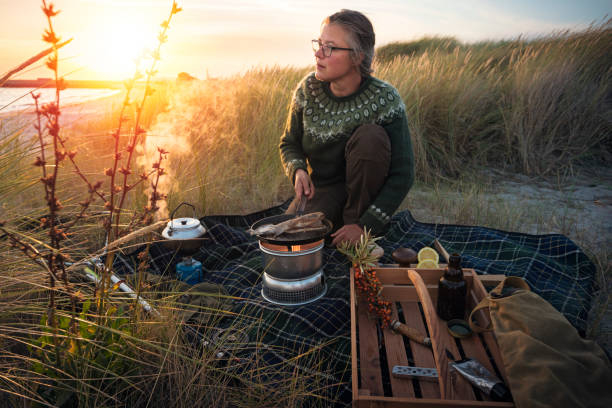 istock Fisherman cooking her catch at the beach 1085649058