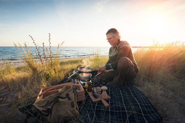 istock Fisherman cooking her catch at the beach 1085649154