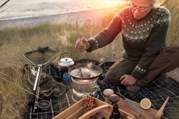 istock Fisherman cooking her catch at the beach 1085649378