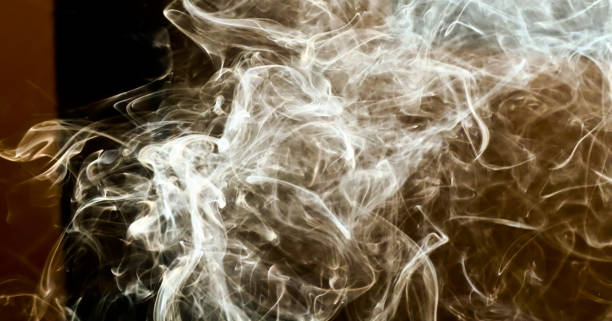 istock Smoke steam in room lighten by sun light smoke background 1085649846
