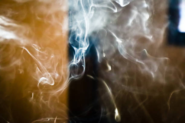 istock Smoke steam in room lighten by sun light smoke background 1085649866