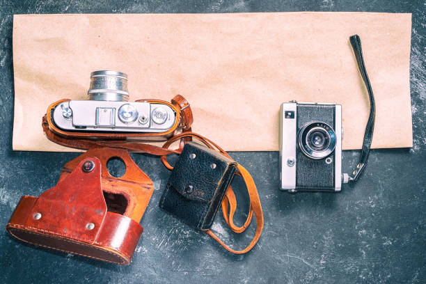 istock Old retro cameras on vintage abstract background with paper strip with copy space for your text. 1085649970