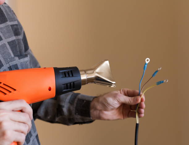istock Apartment-repair. Hands, wire, electric drier, close up 1085659078