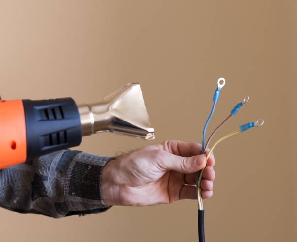 istock Apartment-repair. Hands, wire, electric drier, close up 1085659692