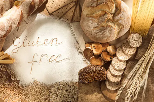 Gluten free food. Various pasta, bread and snacks on wooden background from top view. Healthy and diet concept.