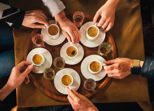 Group of people drinking turkish coffey, top view Group of people with henna mehndi tattoo on the hands drinking turkish coffey, top view turkey tattoo stock pictures, royalty-free photos & images