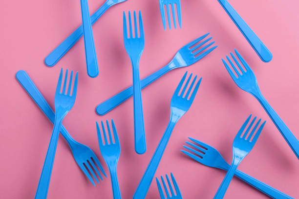istock Close-up of blue forks on pink background 1085663280