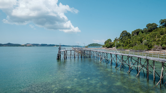 Shot of a fishing pier at Labun Island surrounding by crystal blue water