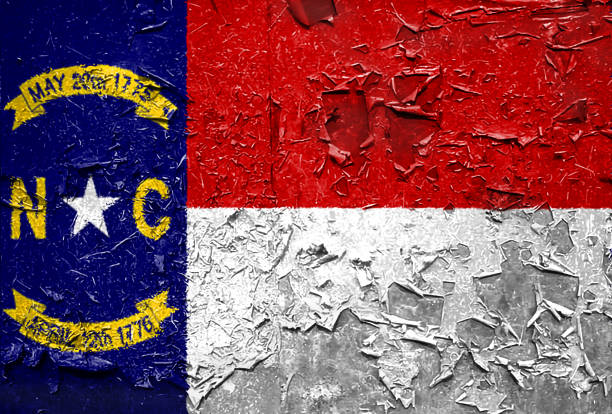 istock North Carolina state Flag emblem on metallic texture 1085677986