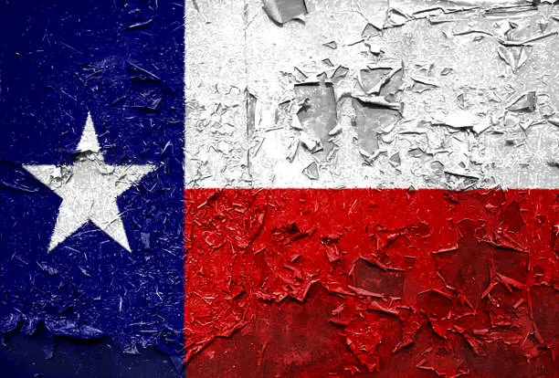 Photo of Texas state Flag emblem on metallic texture